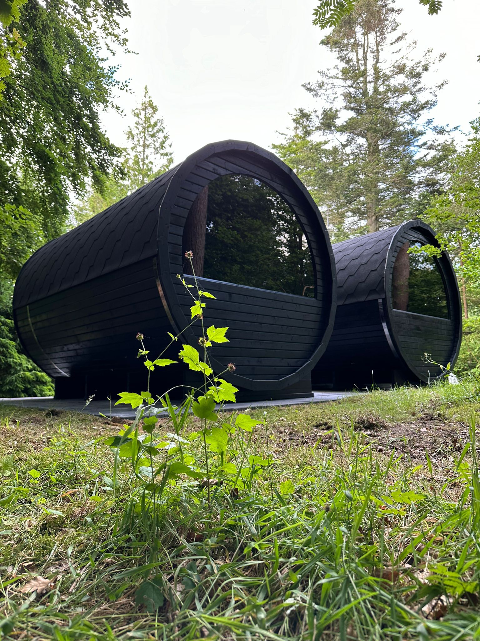 Two barrel saunas installed at a countryside retreat surrounded by forest