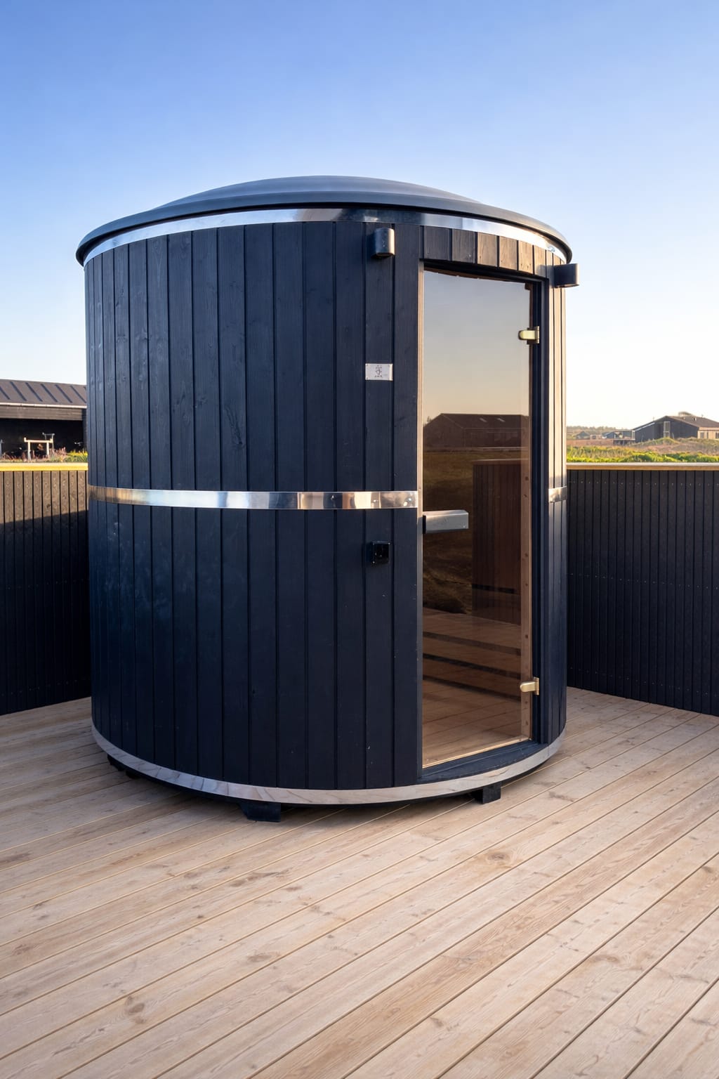 Two-person cylindrical sauna installed on a private home terrace